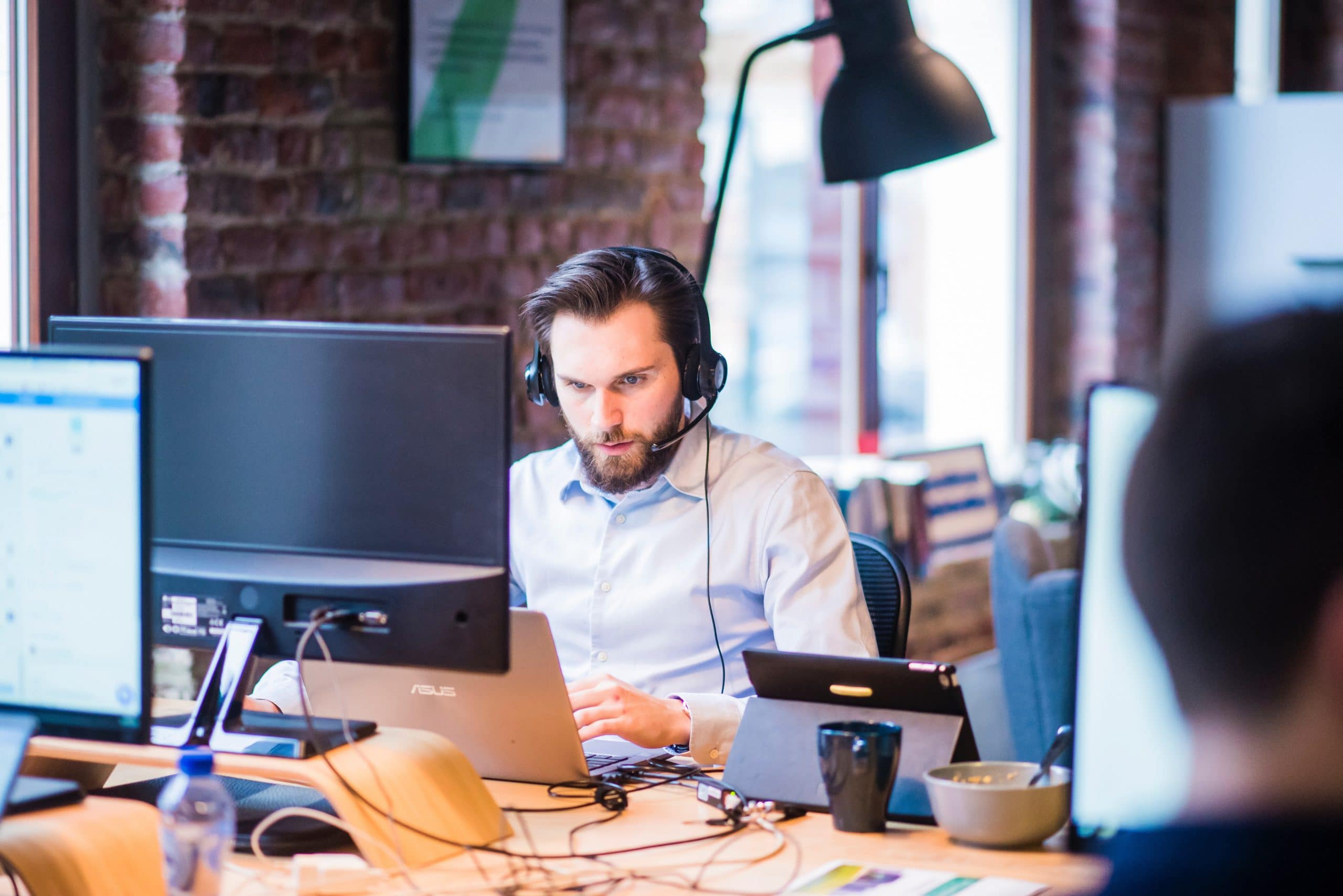 selective-focus-photo-of-man-in-official-shirt-sitting-in-2451645